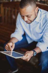 A gentleman using a tablet for his church software